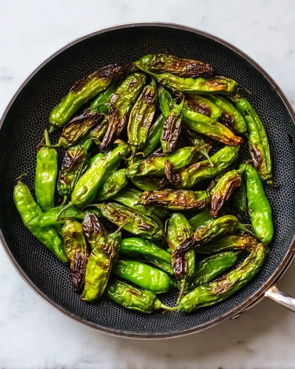 A clear glass bowl filled with many fresh green chili peppers piled loosely, showing their smooth, shiny skin and curved shapes. The bowl rests on a white marbled surface, highlighting the bright green color of the peppers vividly. The peppers are in different sizes, some with stems that curve naturally. photo taken with an iphone --ar 4:5 --v 7