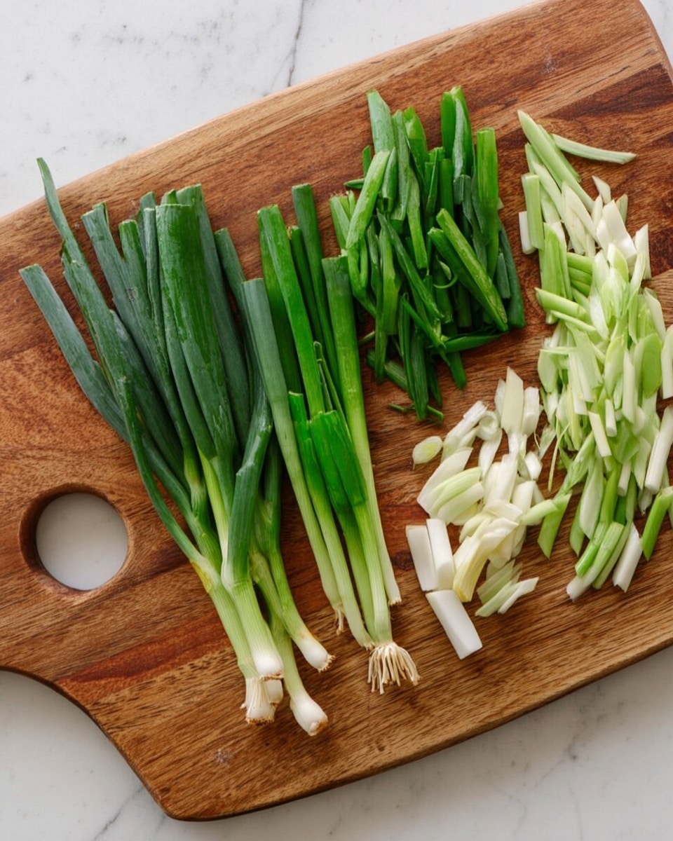 A close-up top view of a small bowl with a wide dark blue rim and creamy white inside, filled with a dark brown sauce that is slightly thick and has small bits floating in it. A metal spoon stands inside the bowl, partly submerged in the sauce. The bowl sits on a white marbled surface with some small reddish crumbs scattered on the right side. photo taken with an iphone --ar 4:5 --v 7